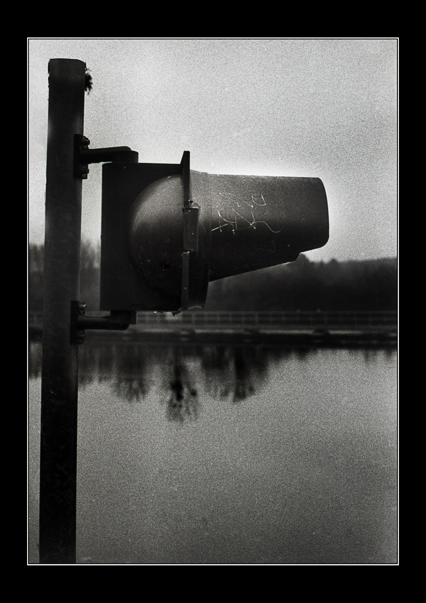 Moody black and white photo Traffic light by the river Photo Oleg Sotnik